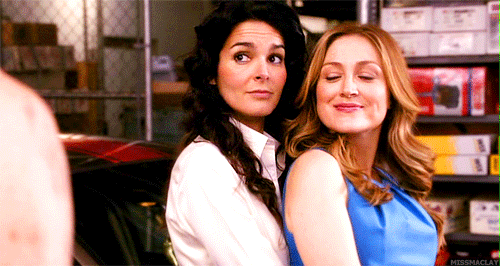 Jane hugging Maura and winking at a guy, implying they are LLBFFs - Life Long Best Friends Forever.