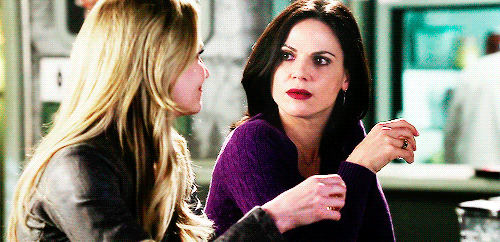 Emma and Regina clinking shots together before drinking.