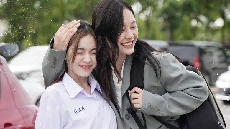 Two people smiling and hugging outdoors, one in a school uniform shirt and the other in a gray blazer.