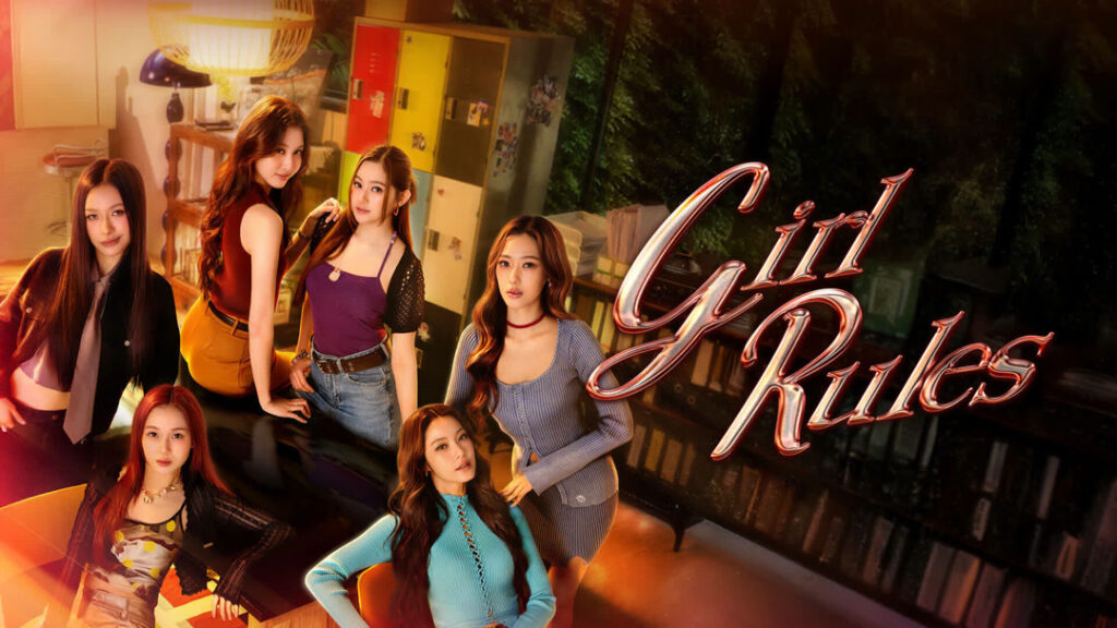 Group of young women posing together in a stylish room with 'Girl Rules' text on a glass wall behind them.