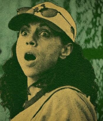 Woman wearing a baseball cap with sunglasses perched on top, her mouth open in surprise.