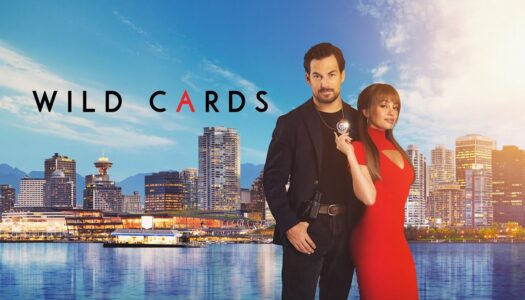Poster for Wild Cards featuring a man in a black suit and a woman in a red dress standing by a city skyline.