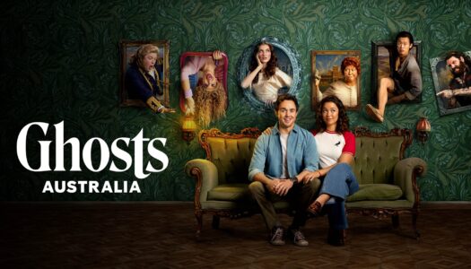 Six people sit on a vintage green sofa against ornate wallpaper with framed portraits on the wall; Ghosts Australia promo image on the left.