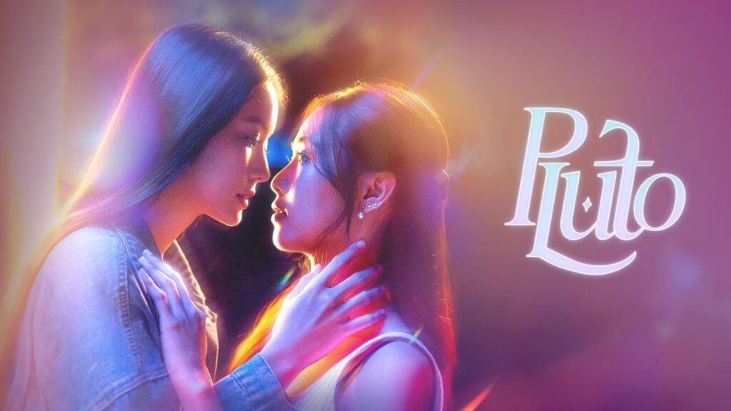 Two young women gaze into each other's eyes, hands gently on each other, under colorful neon lighting with a 'Puto' logo to the right.